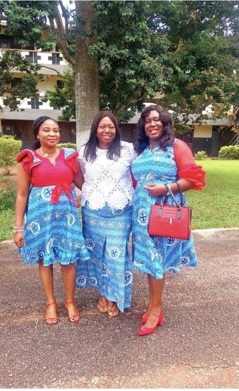 Three friends in blue under the trees