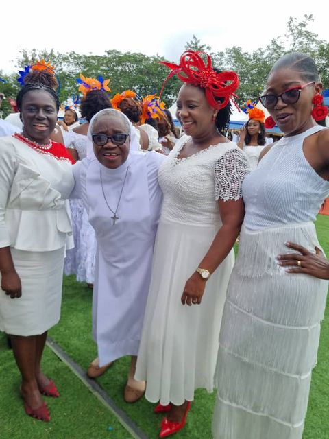 Hats and white outfits at a gathering